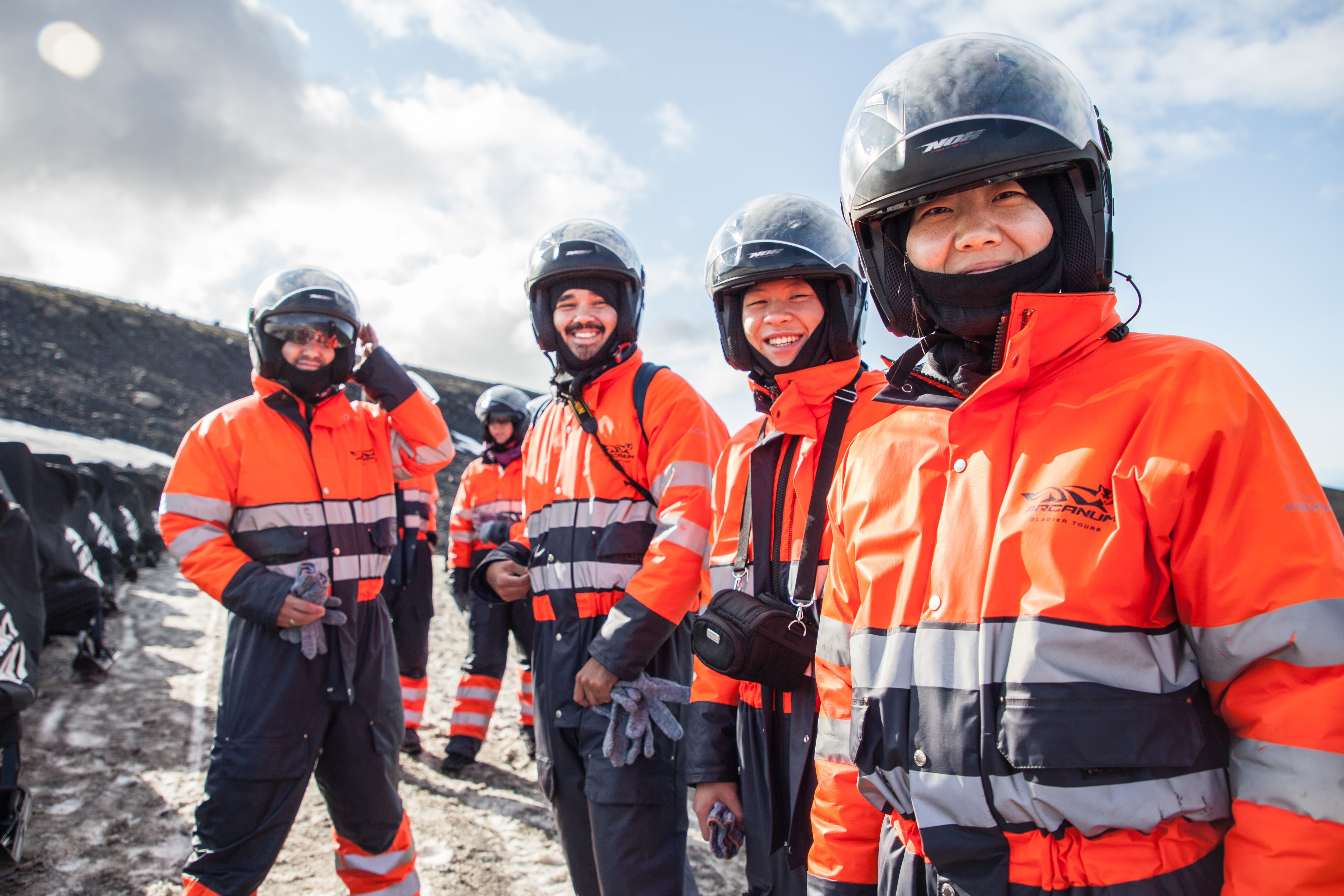 Four people happy after a great snowmobile tour on the glacier